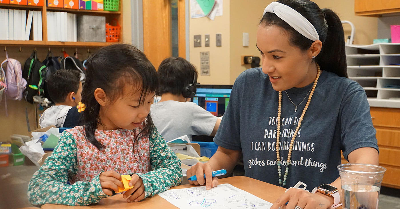 Picture of a teacher working with a student at Great Oaks Elementary